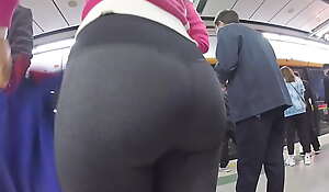 Candid Oriental lady's butt on touching tight yoga pants